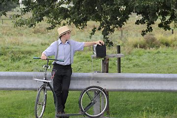 A young Amish boy taking a rest.